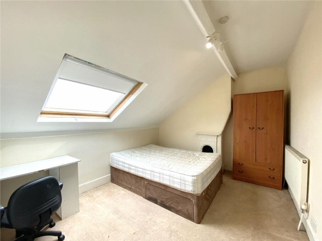 This cozy double bedroom features a comfortable...