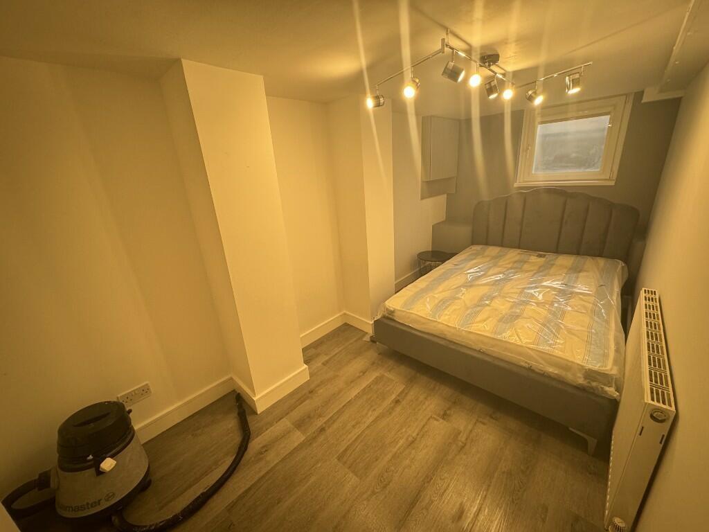 Cozy double bedroom featuring a comfortable bed...