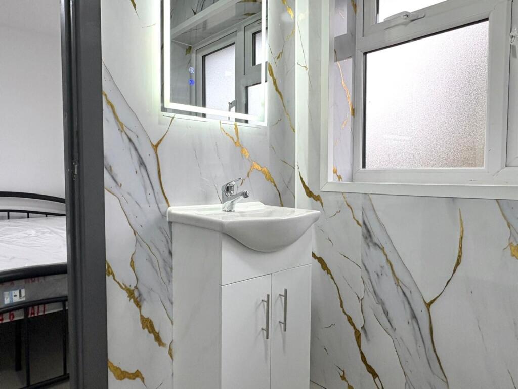 Bright, modern bathroom with sleek white vanity...