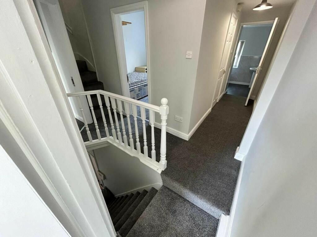 A clean and well-maintained hallway with neutra...