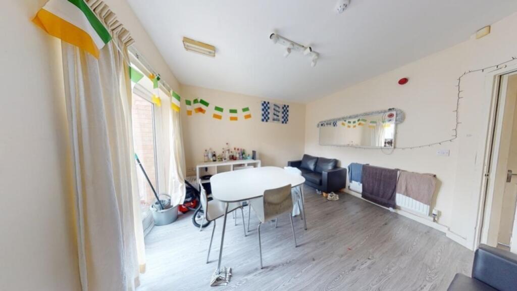 A bright living room featuring large windows wi...