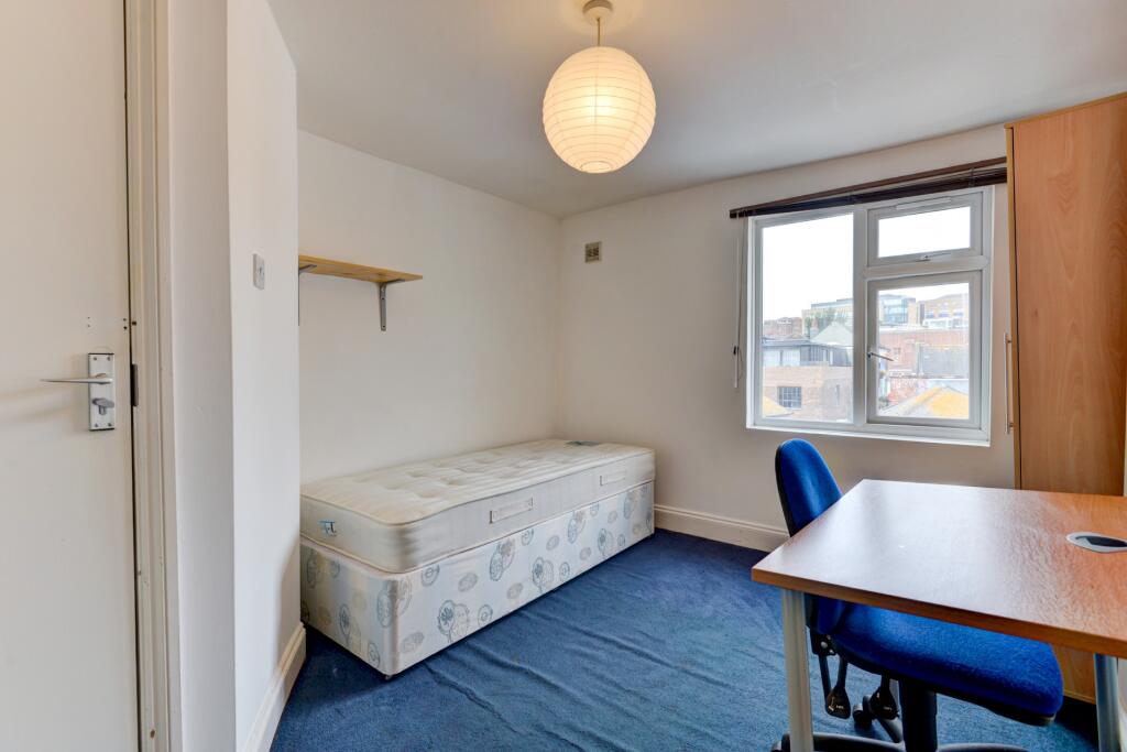 Cozy single bedroom with a comfortable bed, a d...