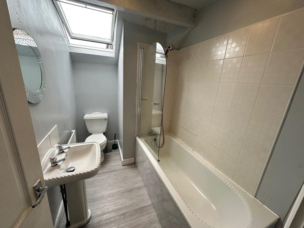 A bright and spacious bathroom suite featuring ...