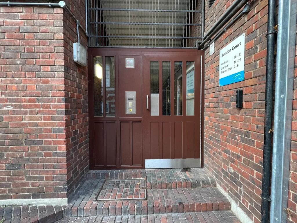 Secure entrance to a brick terraced building fe...