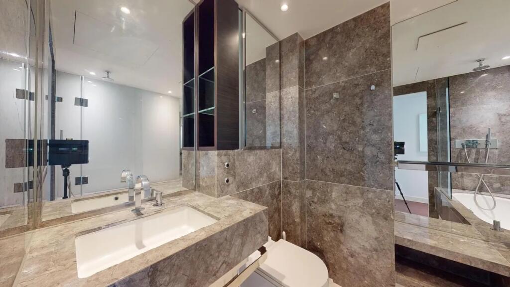 A sleek and modern bathroom suite featuring ele...