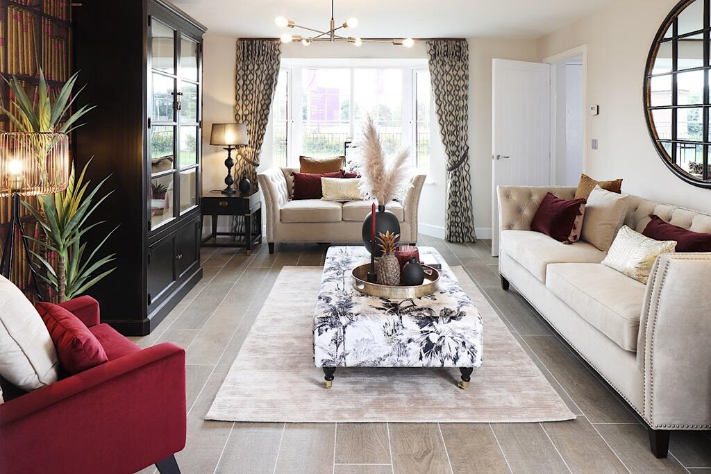 A lounge with bay window floods the room with light