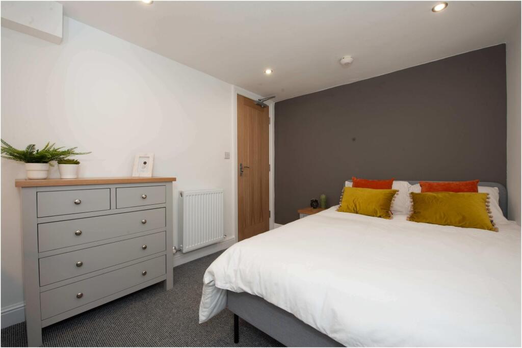 A spacious and well-maintained master bedroom f...