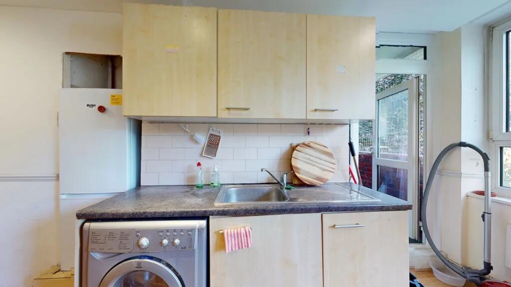 Bright kitchen featuring light wood cabinets, a...