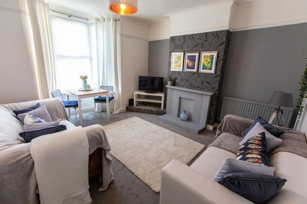 A bright and tidy living room with comfortable ...