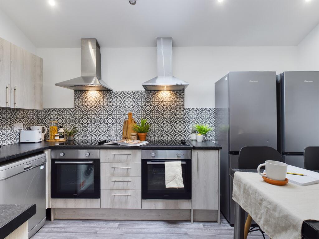 A modern and spacious kitchen featuring stylish...