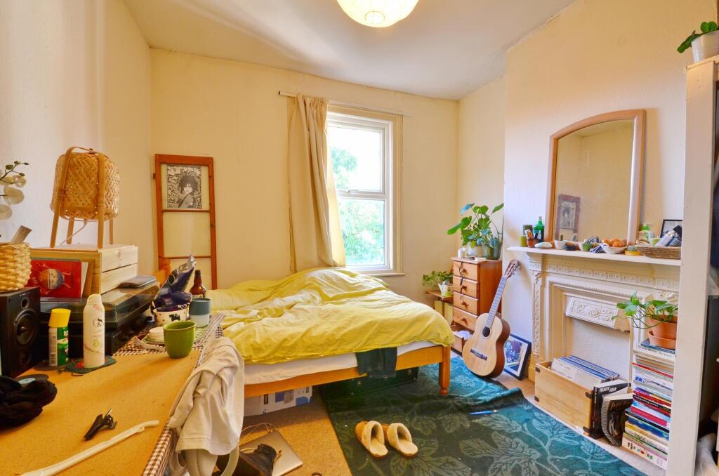 A cozy and charming bedroom featuring a comfort...
