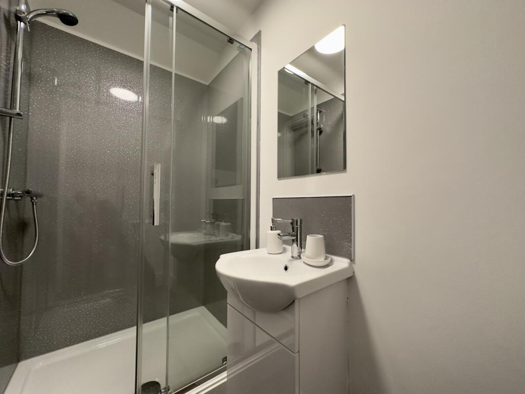 A modern and pristine bathroom featuring a spac...