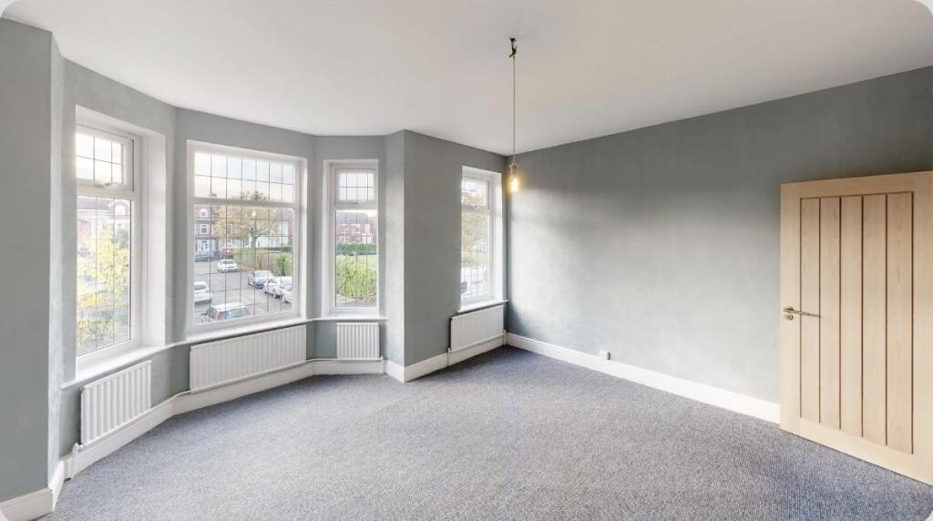 A spacious master bedroom featuring a beautiful...