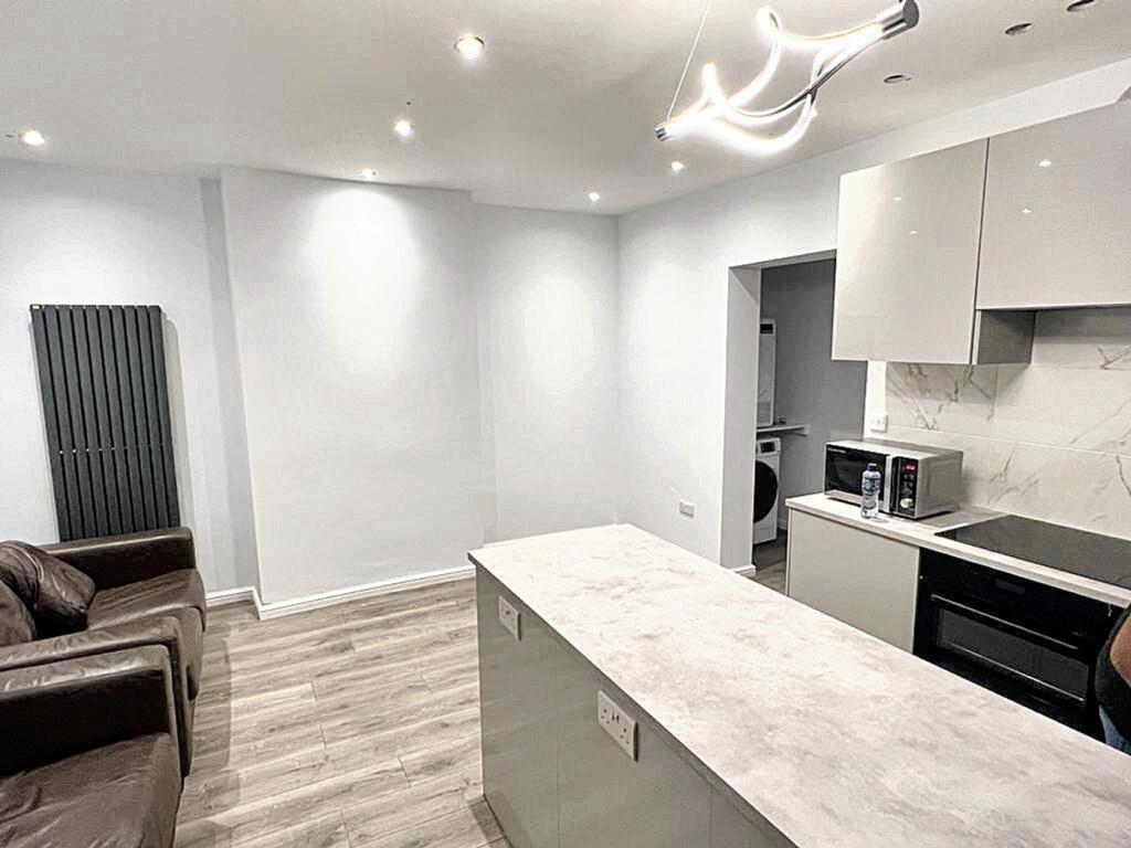 Modern kitchen featuring sleek cabinetry and am...