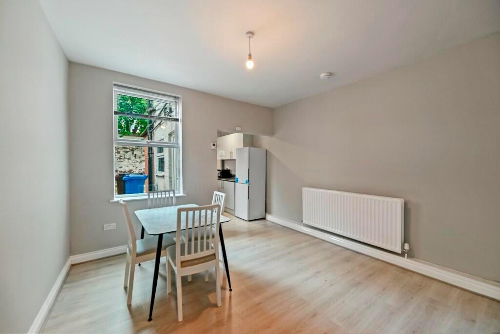 Bright and clean kitchen area featuring light w...