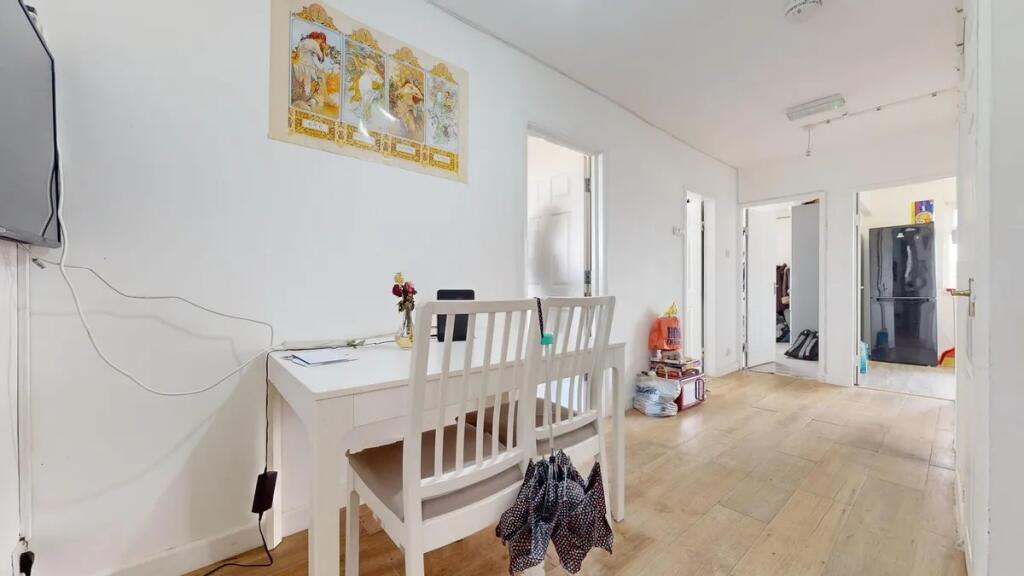 Bright and clean hallway with light wooden floo...