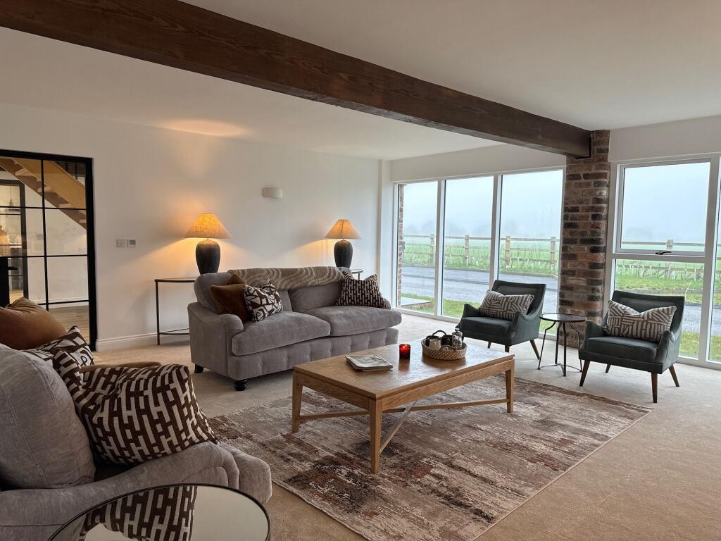 Main lounge with exposed brick and character beams