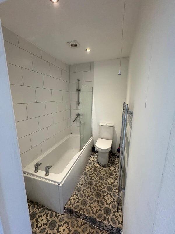 Bright and stylish bathroom featuring a clean w...