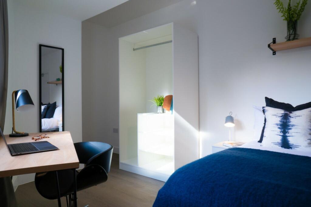 A bright and modern double bedroom featuring a ...