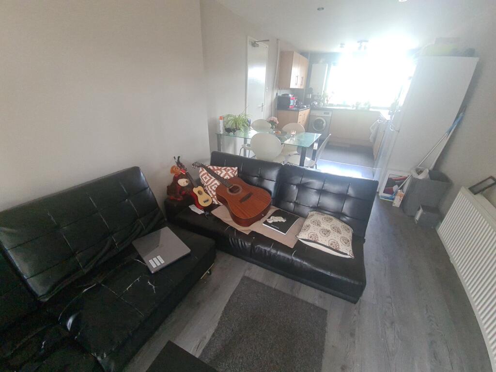 A cozy and modern living room with dark leather...