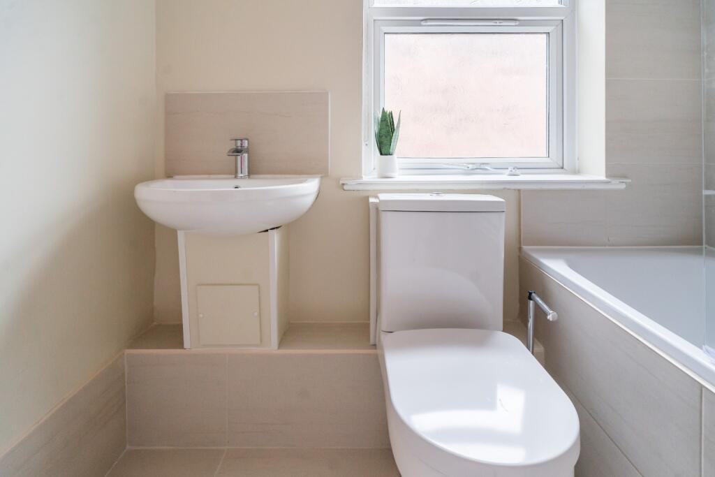 A modern bathroom featuring sleek fixtures, a s...