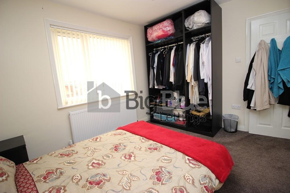 Cozy double bedroom featuring a comfortable bed...
