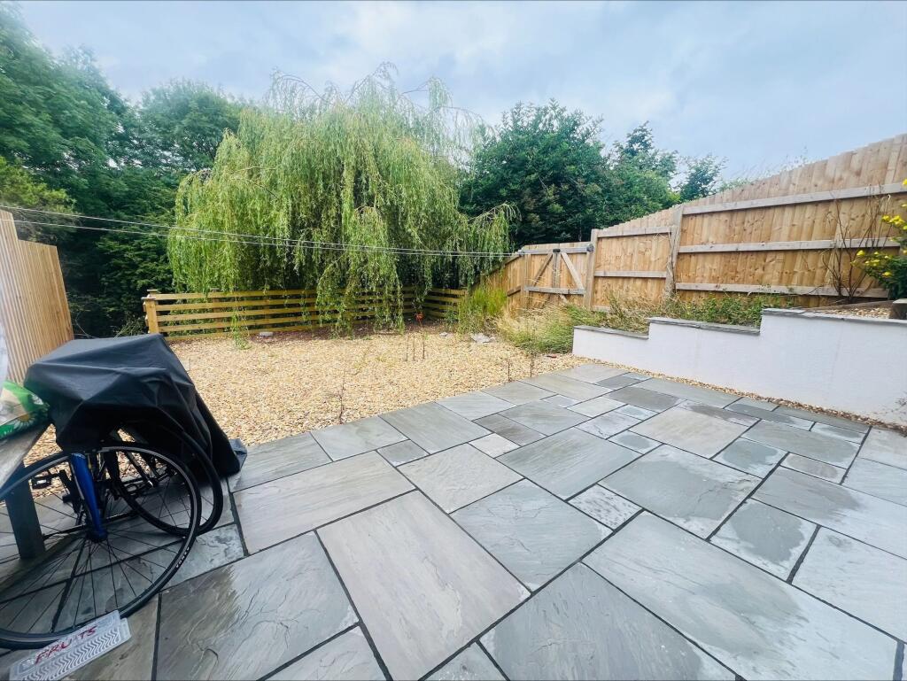 A spacious and well-maintained garden area feat...