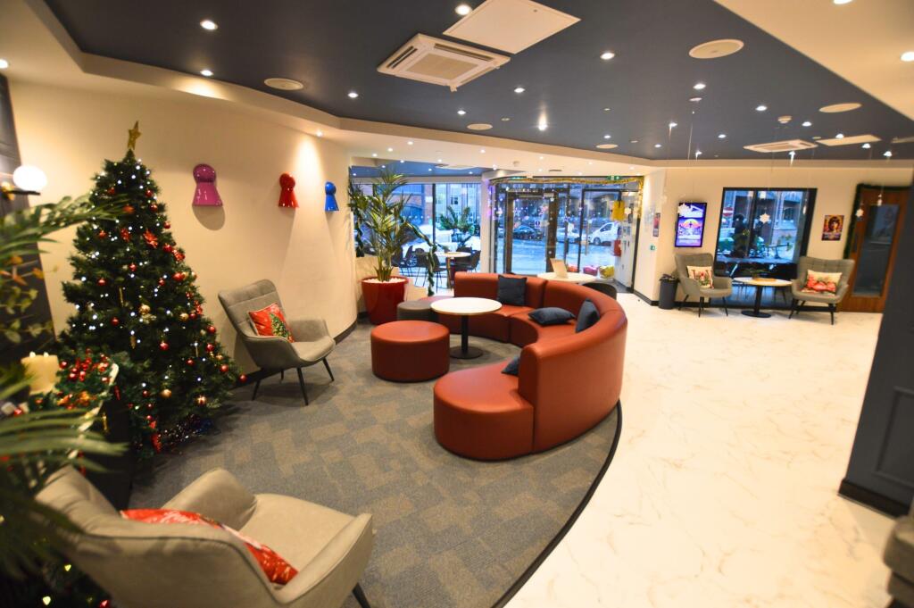 A stylish communal lounge featuring modern curv...