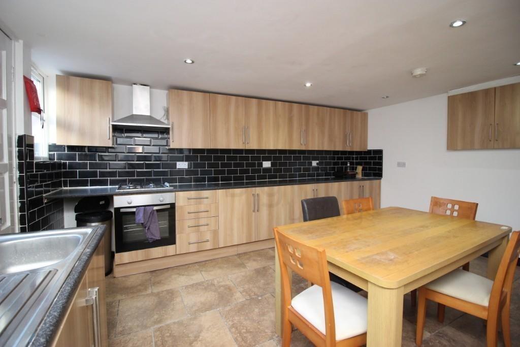 Bright and modern kitchen featuring ample cabin...