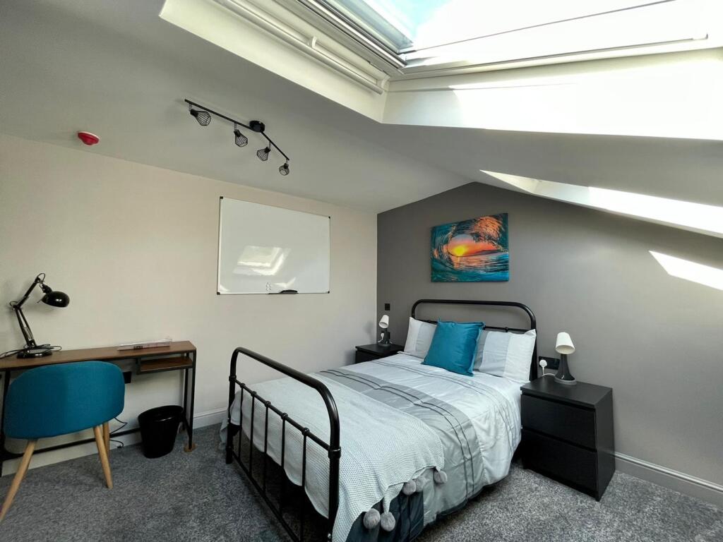 A bright and inviting double bedroom featuring ...