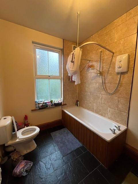 A well-maintained bathroom featuring a bathtub ...