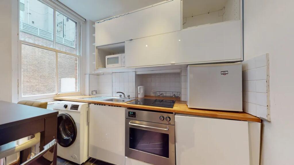Bright and tidy kitchen space featuring modern ...