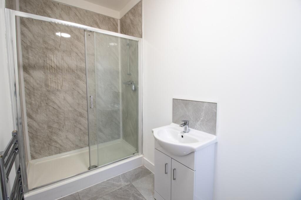 A modern bathroom with a shower enclosure and a...