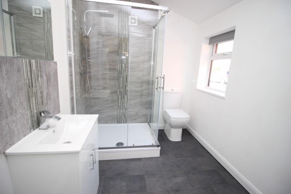 Bright and modern bathroom suite featuring a sp...