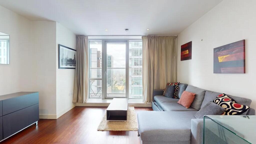 Bright and contemporary living room featuring a...