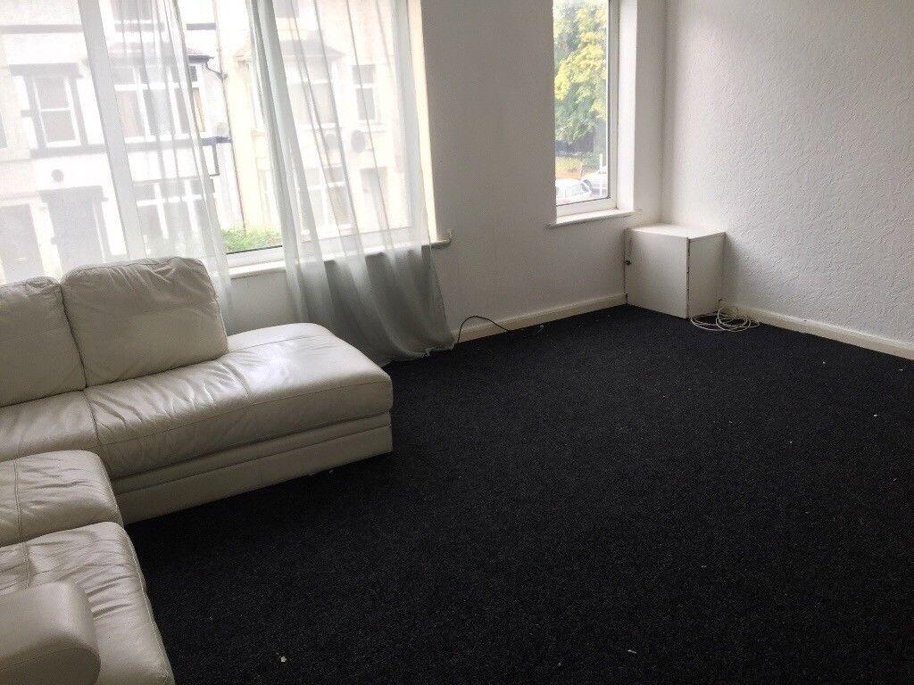 Bright living room with large street-facing win...