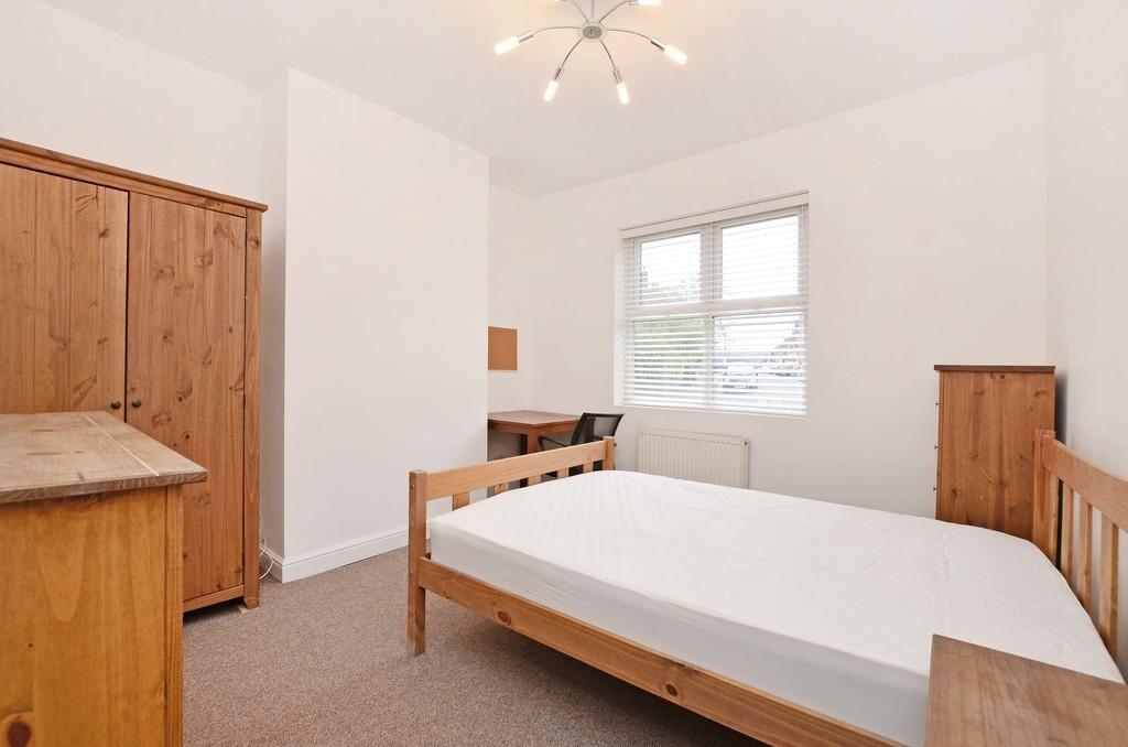 A bright and tidy double bedroom featuring natu...