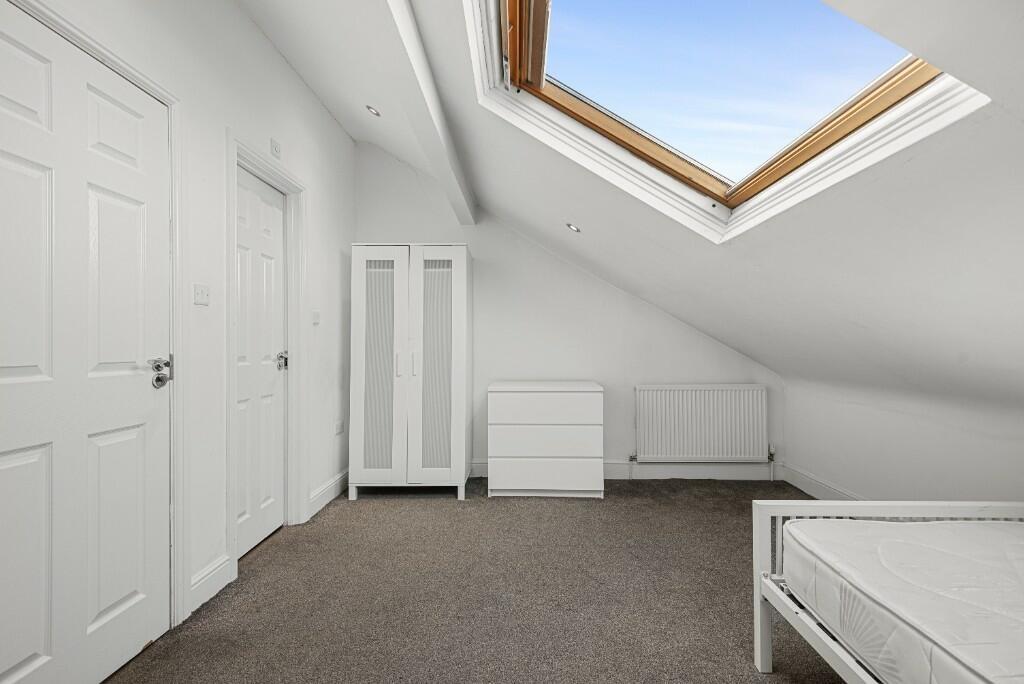 A bright and tidy double bedroom featuring a sl...