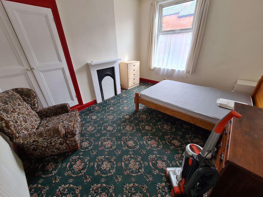 A cozy single bedroom featuring a comfortable a...