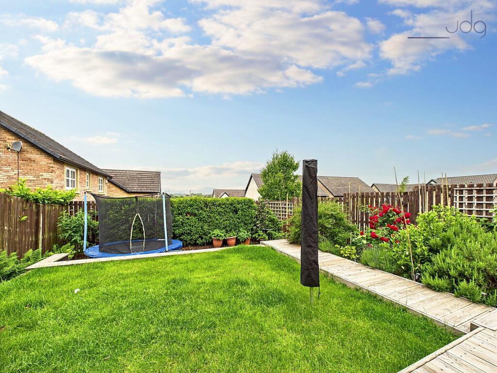 Tiered with steps up from the patio to a raised lawn