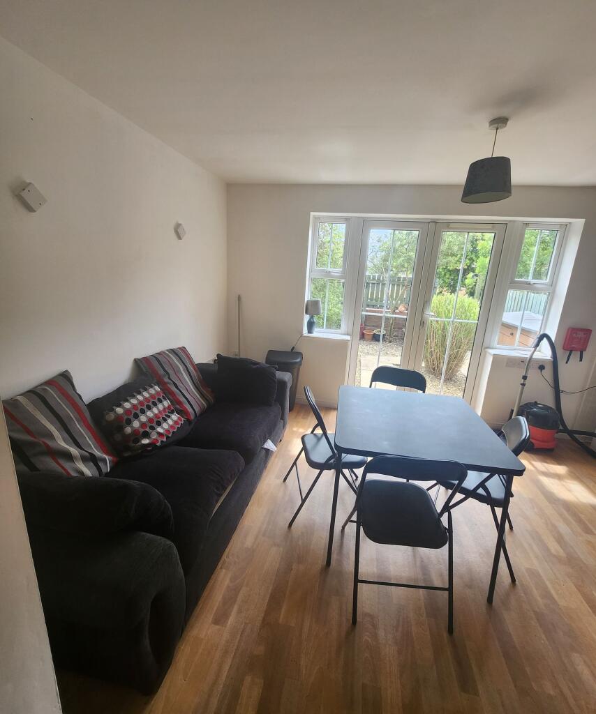 A cozy living room featuring a comfortable dark...