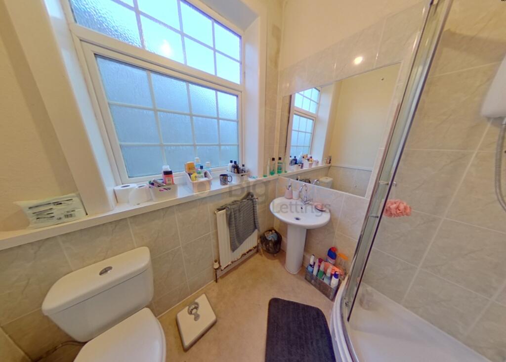 Bright and tidy bathroom featuring a large fros...