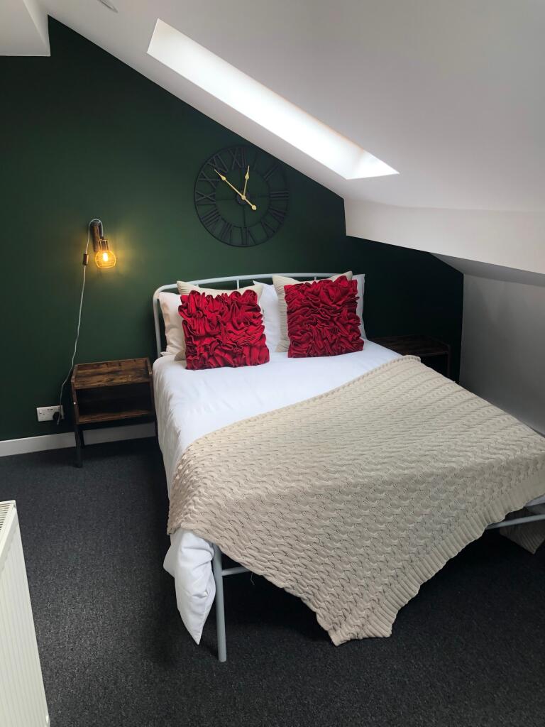 A stylish and cozy double bedroom featuring mod...