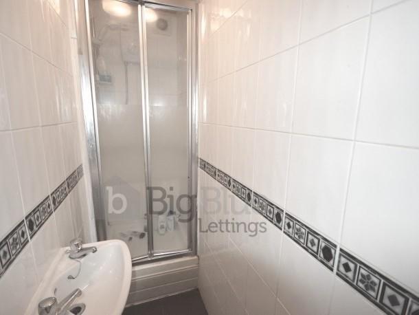 Bright and clean bathroom featuring a shower en...