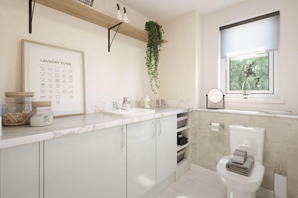 A convenient cloakroom and utility room, both located off the hallway for easy access and everyday