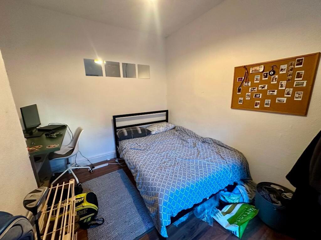 Cozy single bedroom featuring a comfortable bed...