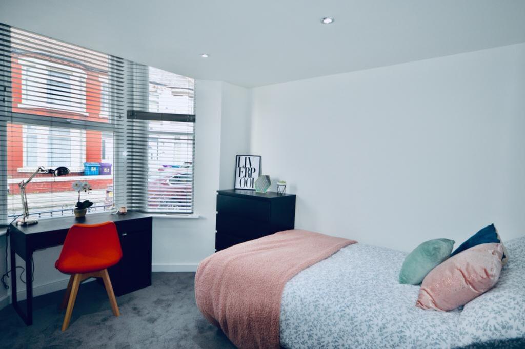 A bright and inviting double bedroom with moder...