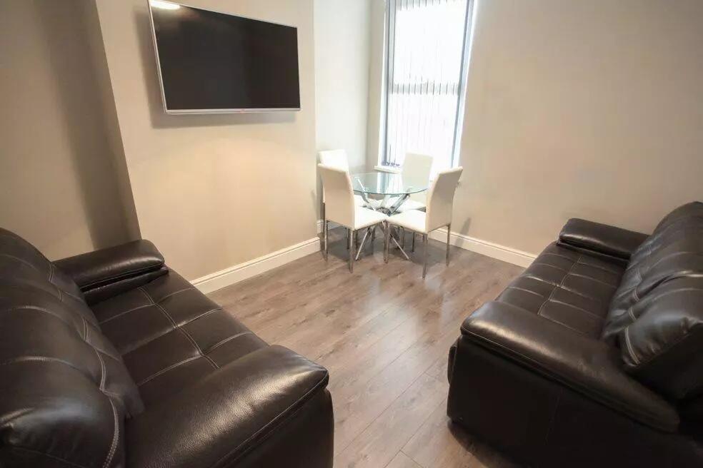 A cozy living room featuring two black leather ...