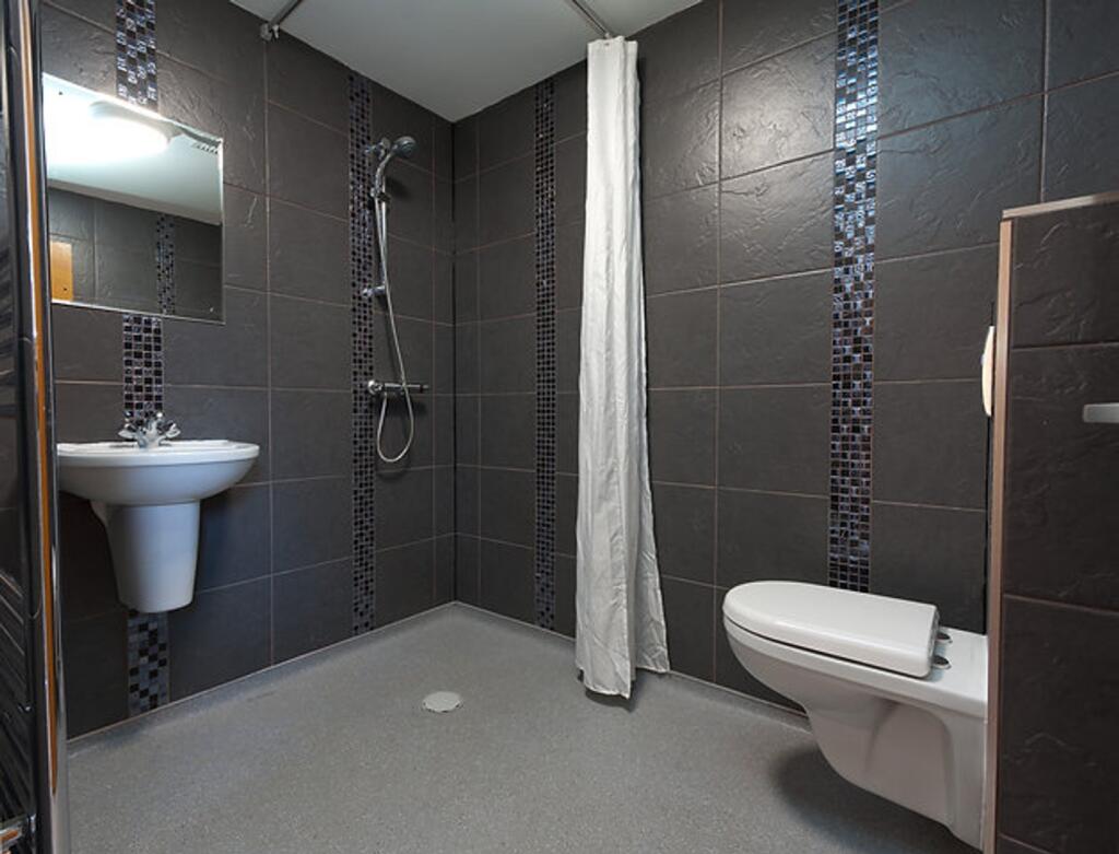 A modern and stylish bathroom featuring elegant...