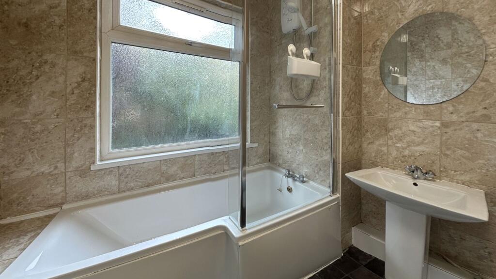 Bright and functional bathroom with a bathtub a...